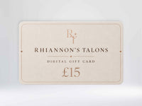 A digital gift card for Rhiannon's Talons, valued at £15, shown on a light gray gradient background. The card is a warm cream color with elegant rose gold typography and border details.