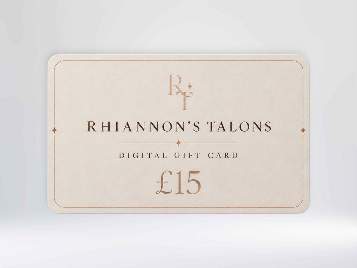 A digital gift card for Rhiannon's Talons, valued at £15, shown on a light gray gradient background. The card is a warm cream color with elegant rose gold typography and border details.