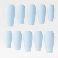 Ten light blue press-on nails arranged in two rows of five on a white display card.
