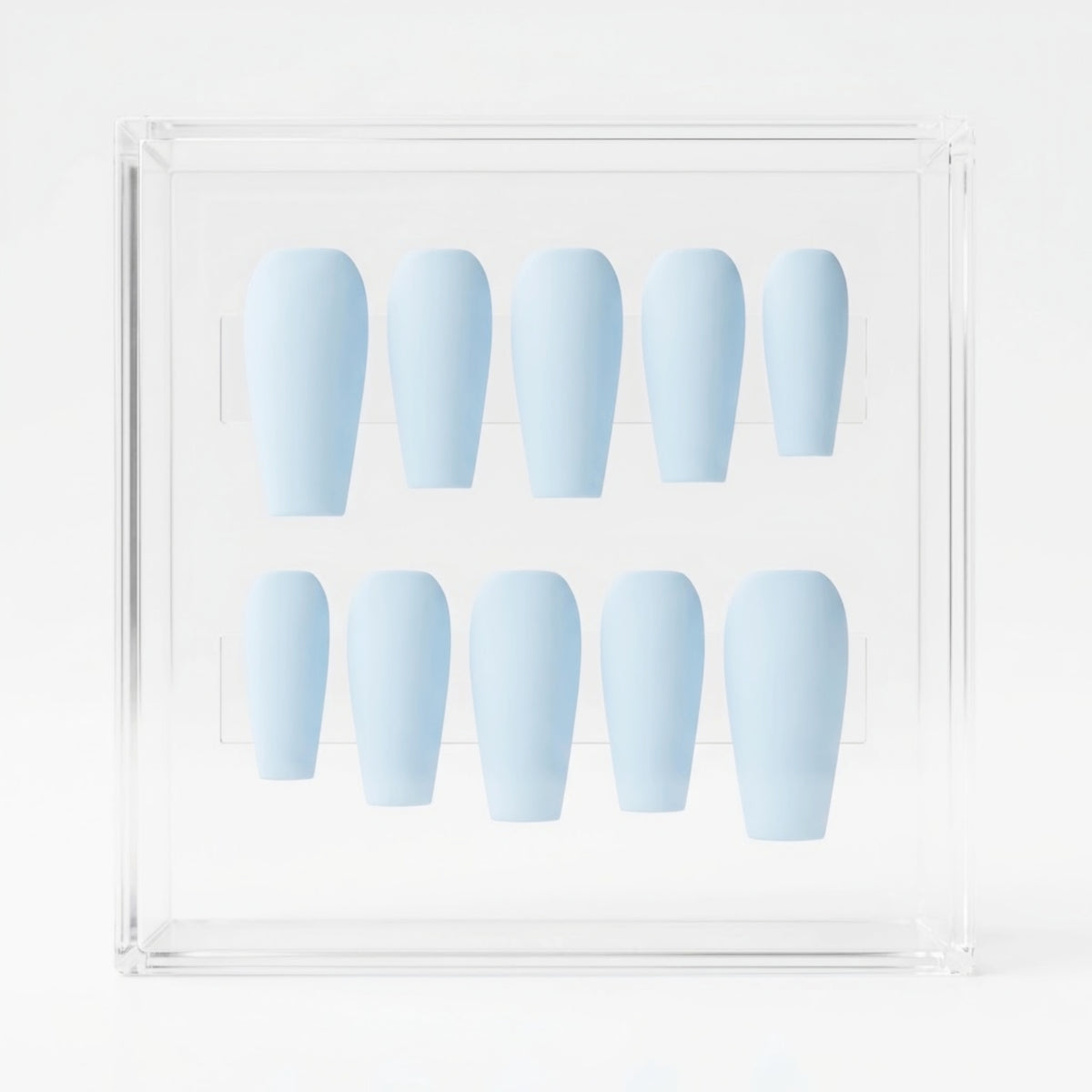 A set of ten light blue press-on nails arranged in two rows inside a clear acrylic display box on a white background.