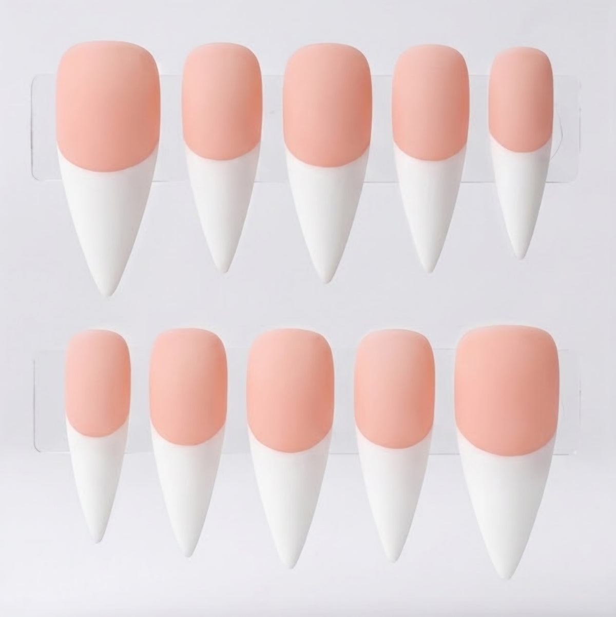 Ten stiletto-shaped press-on nails arranged in two rows on a clear display card against a white background. Each nail has a soft peach-pink base and white french tips.
