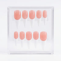 A set of 10 false press-on nails in a clear acrylic display box, featuring a glossy peachy-pink color base and white french tips.