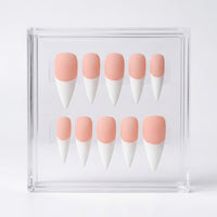 Ten false press-on nails arranged in two rows inside a clear acrylic display box. The nails have a soft peach-pink base and white french tips.