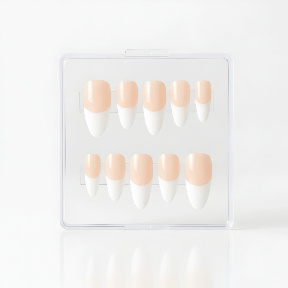 A set of ten coffin press-on nails in a clear plastic case, featuring a classic glossy white French manicure with a pale peach nude base.