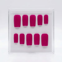 A set of ten berry pink press-on nails arranged in two rows inside a clear plastic display box on a white background.