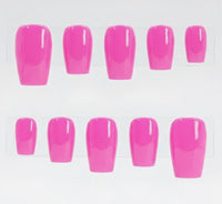 A set of glossy bright pink press-on nails displayed on clear plastic hangers against a white background.