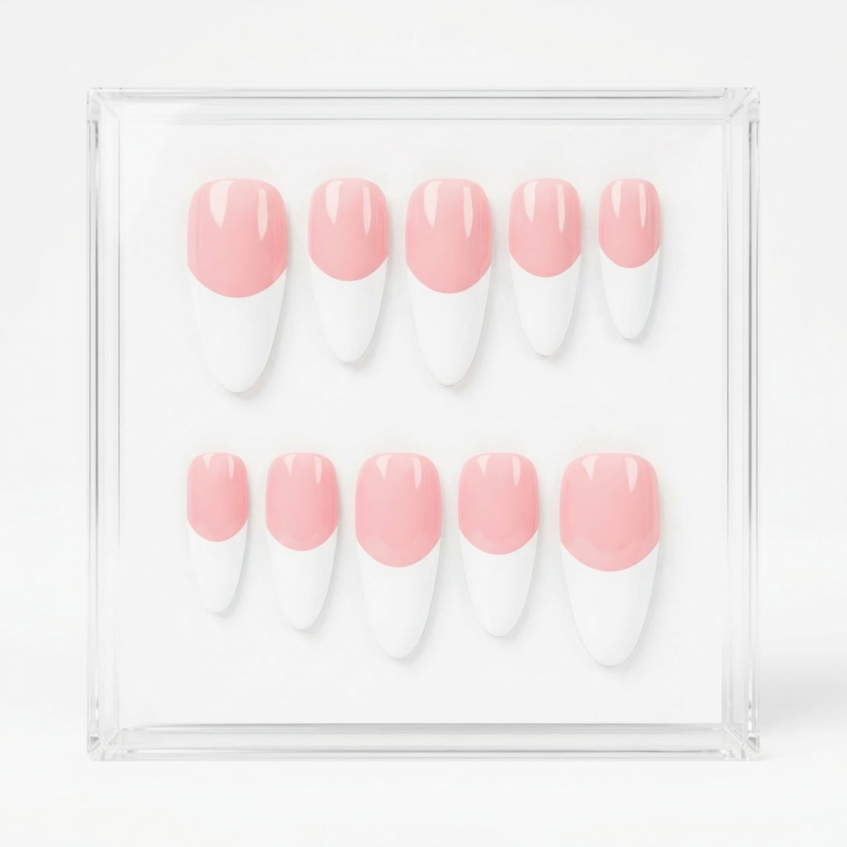 A set of ten press-on nails with a pink and white French tip design, displayed inside a clear acrylic case on a white background.