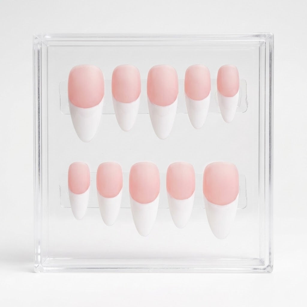 A set of ten press-on nails with a matte pink and white French tip design, displayed inside a clear acrylic case on a white background.