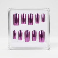 A set of metallic chrome pink press-on nails displayed inside a clear acrylic case on a white background.