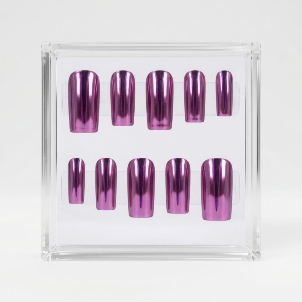 A set of metallic chrome pink press-on nails displayed inside a clear acrylic case on a white background.