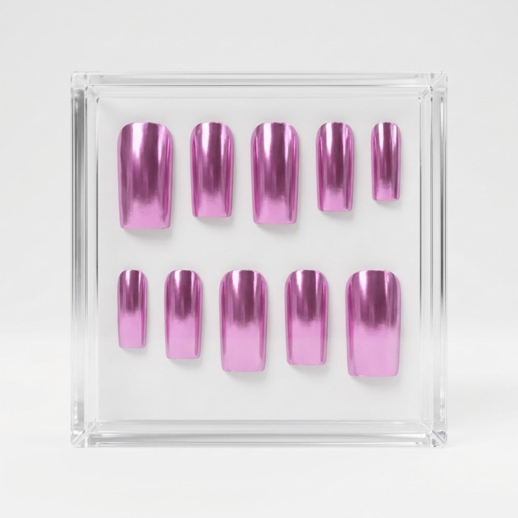 A set of metallic chrome pink press-on nails arranged inside a clear square plastic case on a light gray background.