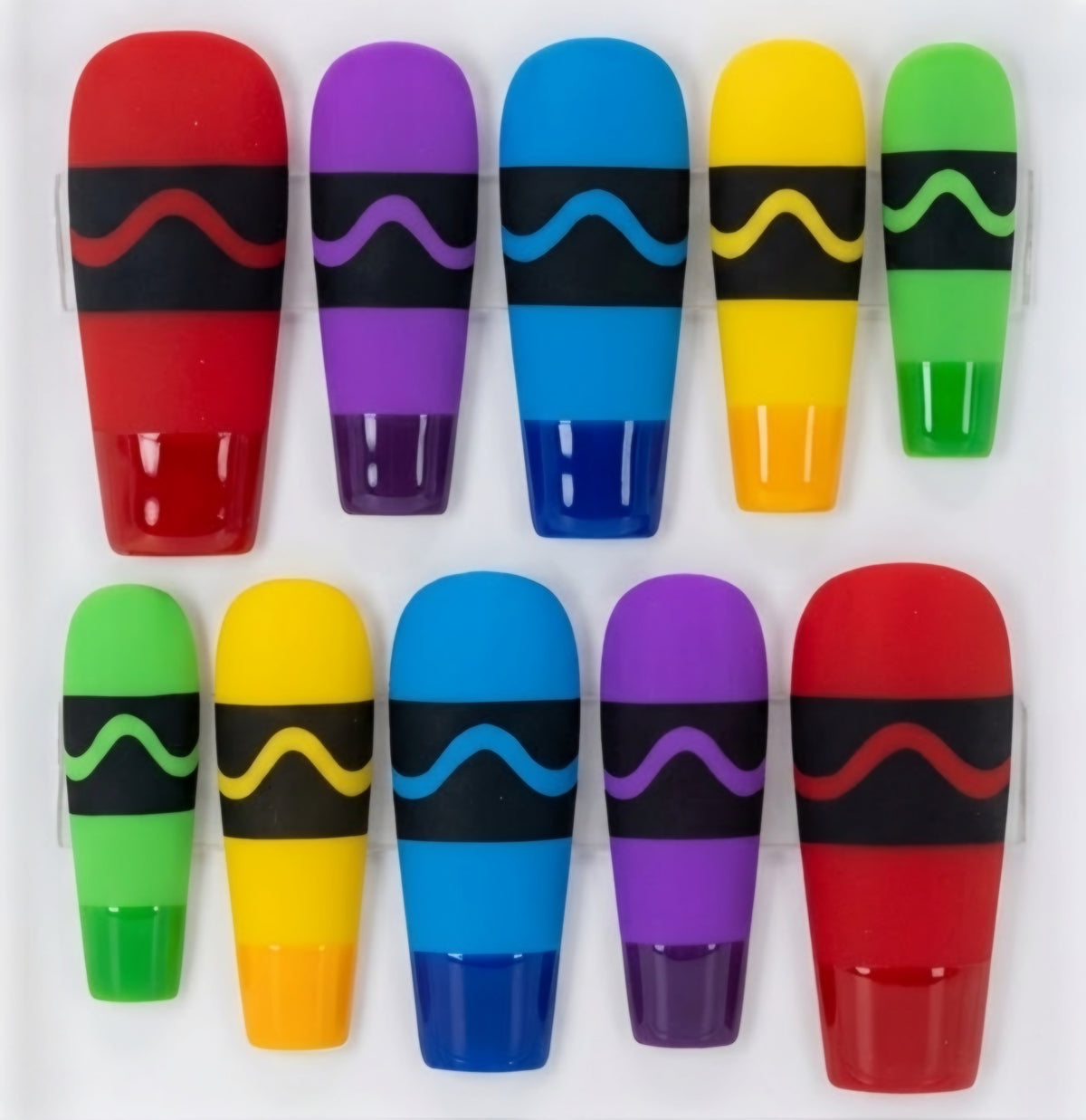 Ten coffin crayon themed press-on nails arranged in two rows on a white background, each in a different bright color with a black band and a wavy accent stripe.