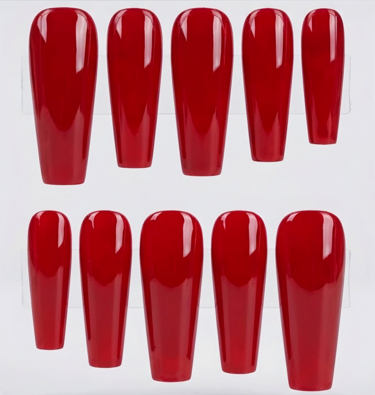 Ten glossy red coffin shaped press-on nails arranged in two rows on a white background.