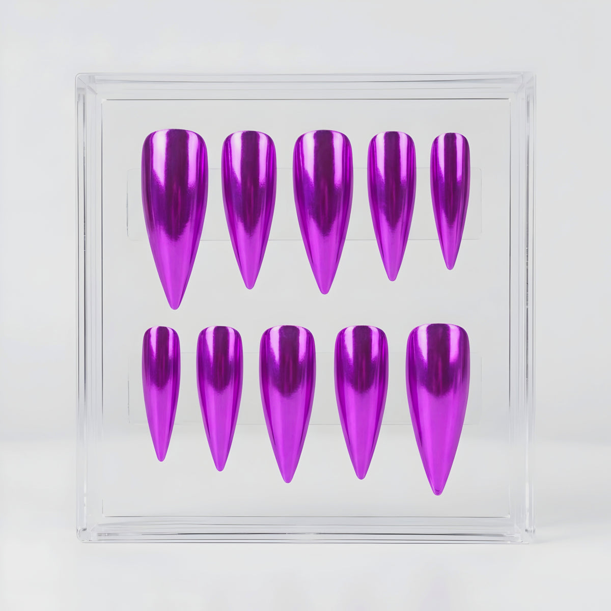 Ten metallic purple false press-on nails arranged in two rows inside a clear acrylic display box on a white background.