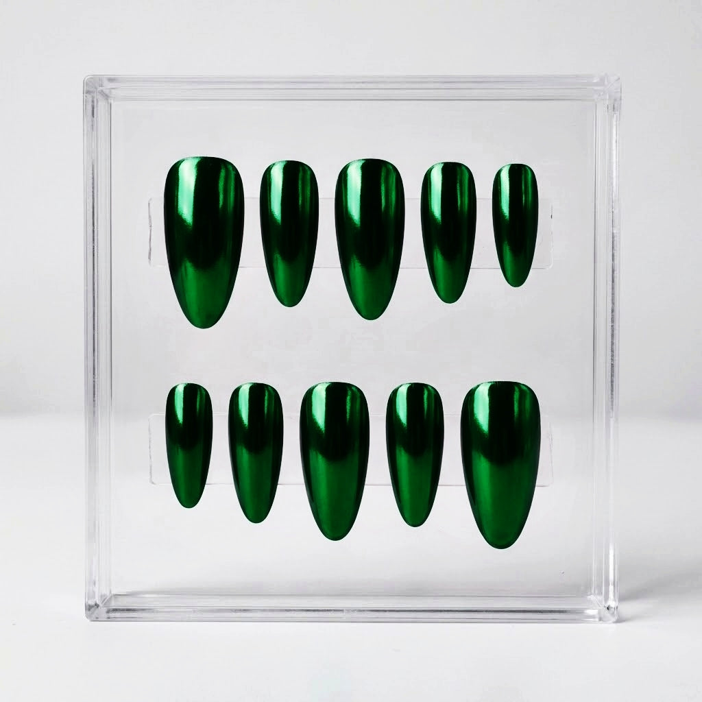 A set of ten glossy metallic chrome green press-on nails displayed in a clear acrylic holder against a light gray background.