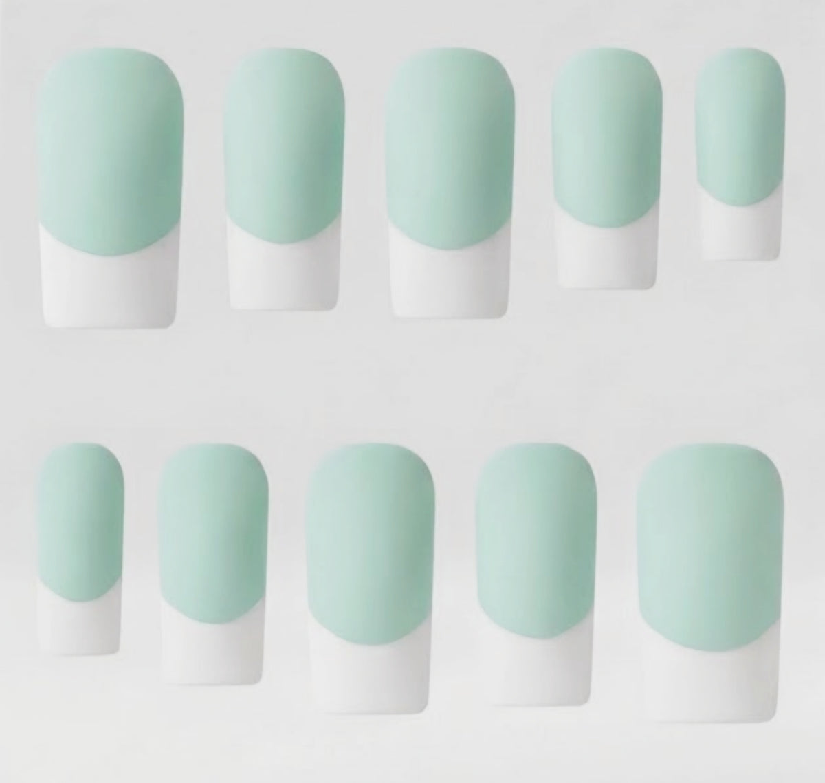 Ten press-on nails arranged in two rows on a plain light background. Each nail has a rounded almond shape with a pale mint green base and white french tips, creating a French manicure-style color-block look.