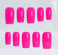 Ten neon hot pink press-on nails arranged in two rows of five on a clear plastic display card against a white background.
