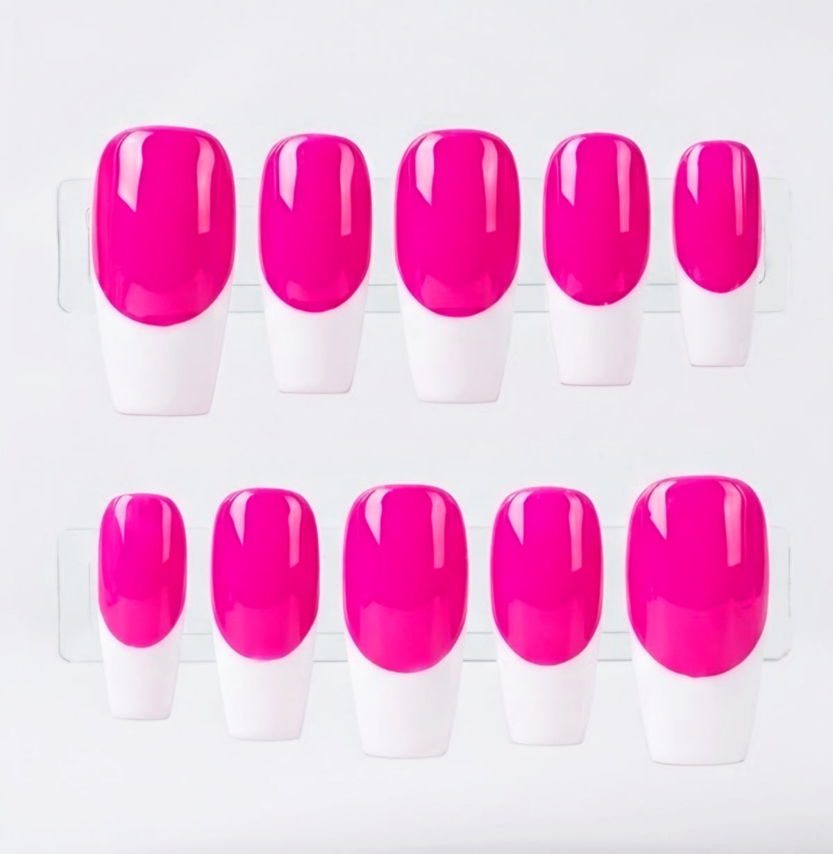 Ten press-on nails arranged in two rows of five, featuring a glossy neon pink base and  white french tips displayed on clear plastic stands against a light gray background.