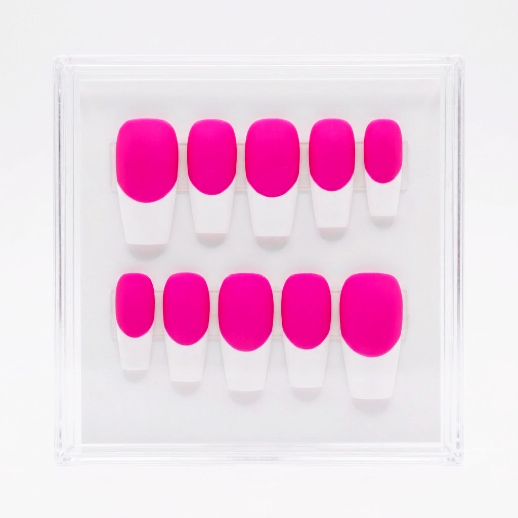 A set of press-on nails in a clear plastic display case, featuring a bold neon pink base and white french tips, arranged in two rows of five.