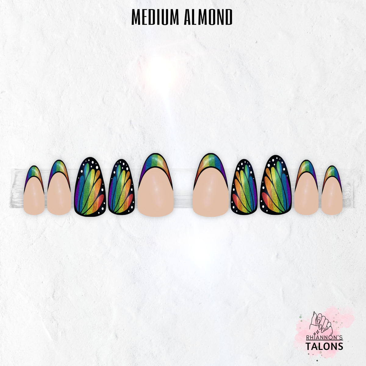 Flutterfly butterfly wing press-on nails with nude base, black wing nail art, shimmer colour accents and glossy medium almond false nails.