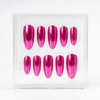 A set of ten metallic chrome hot pink press-on nails displayed inside a clear plastic square case against a white background.