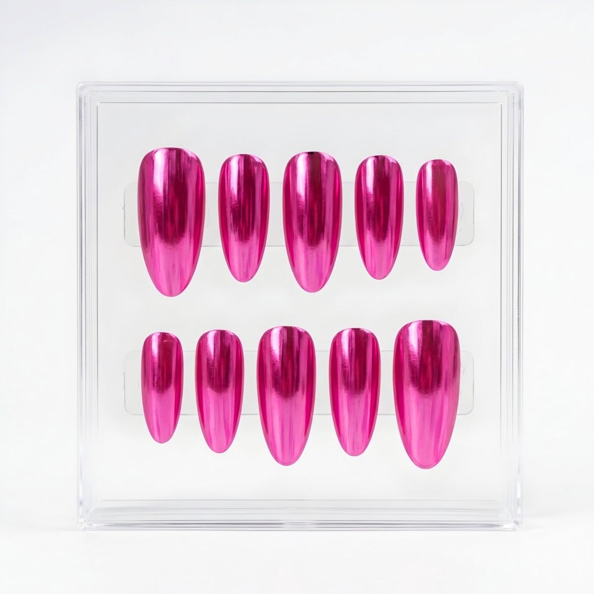 A set of ten metallic chrome hot pink press-on nails displayed inside a clear plastic square case against a white background.