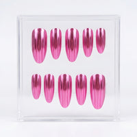 A set of ten metallic chrome pink press-on nails displayed inside a clear acrylic box against a white background.