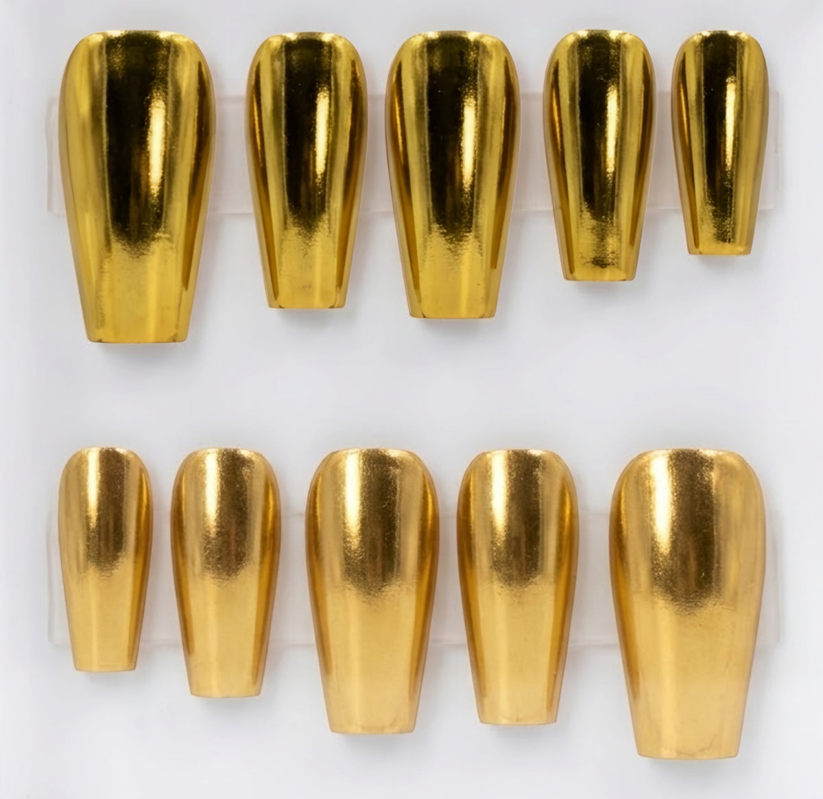 Ten metallic gold chrome coffin-shaped press-on nails arranged in two rows on a white background.