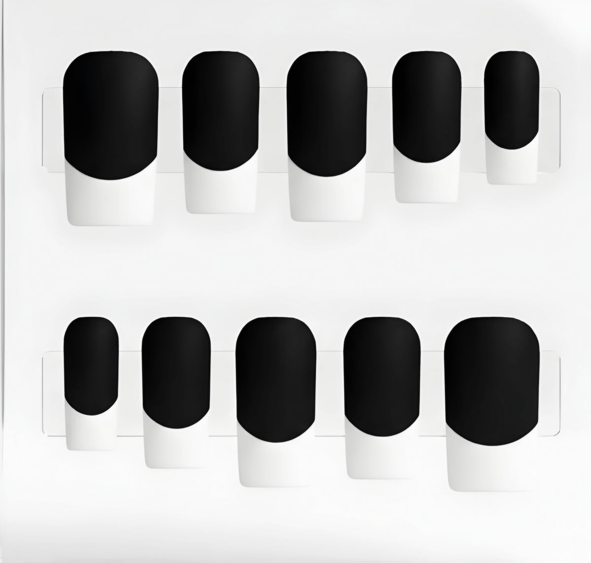 Ten press-on nails arranged in two rows on a white backing. Each nail has a matte black base and white french tips.
