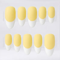 Ten false press-on nails arranged in two rows on a clear display card, featuring a matte pale yellow base and a white French tip.