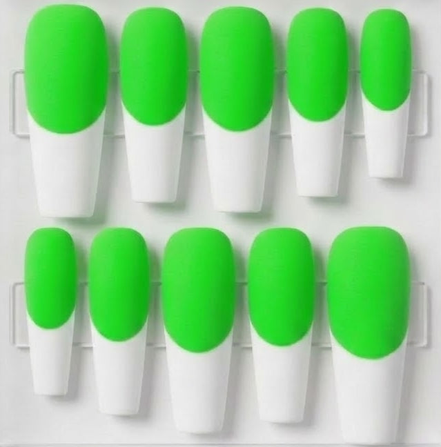 A set of ten press-on nails with a bright neon green and white French tip design, arranged in two rows on a clear plastic display tray.