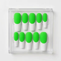 Ten false press-on nails arranged in a clear plastic case, featuring a bright neon green base and white french tips, on a plain white background.