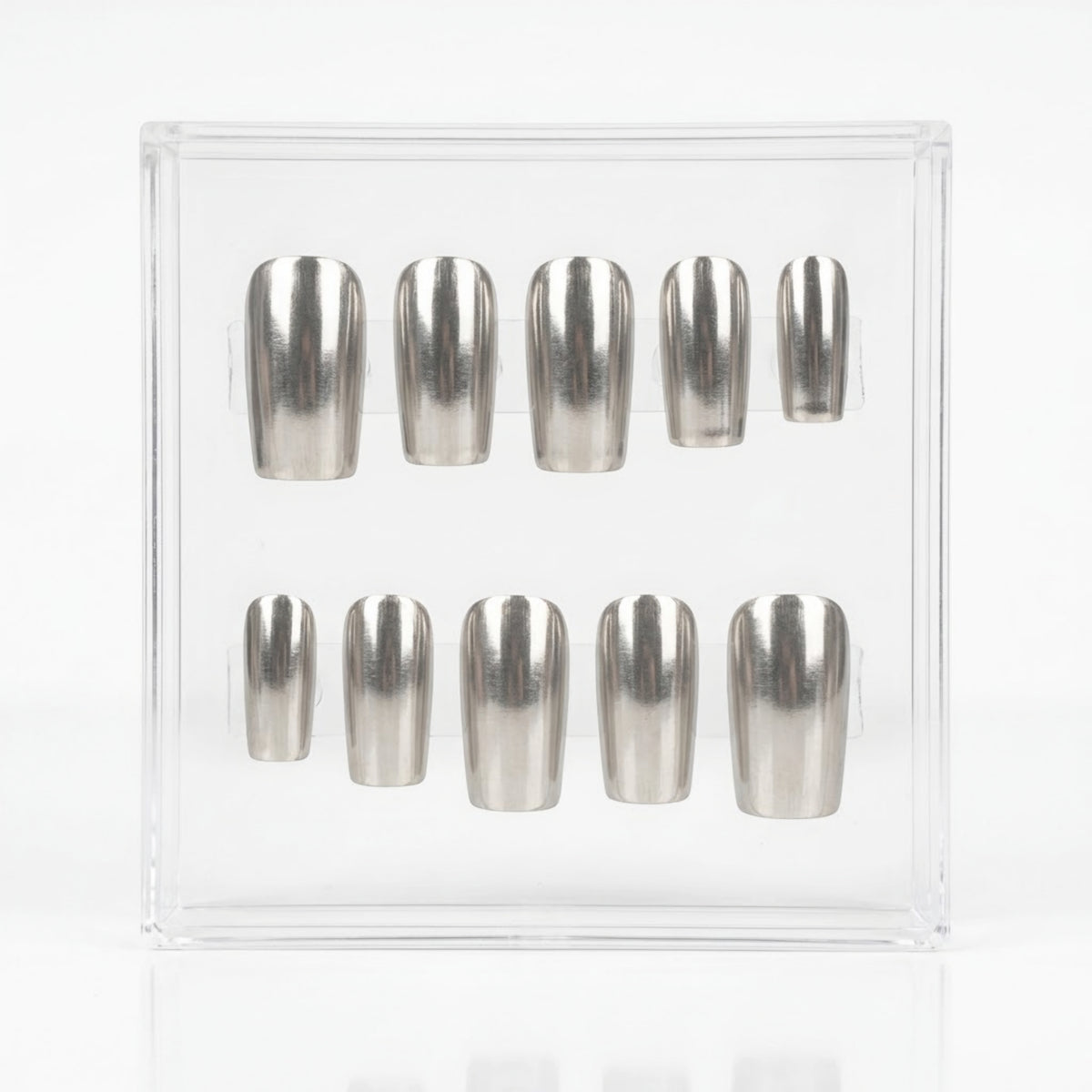Ten metallic silver chrome press-on nails arranged in two rows inside a clear plastic display box on a white background.
