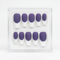 A set of 10 press-on nails with a purple and white French tip design, displayed inside a clear plastic case on a white background.