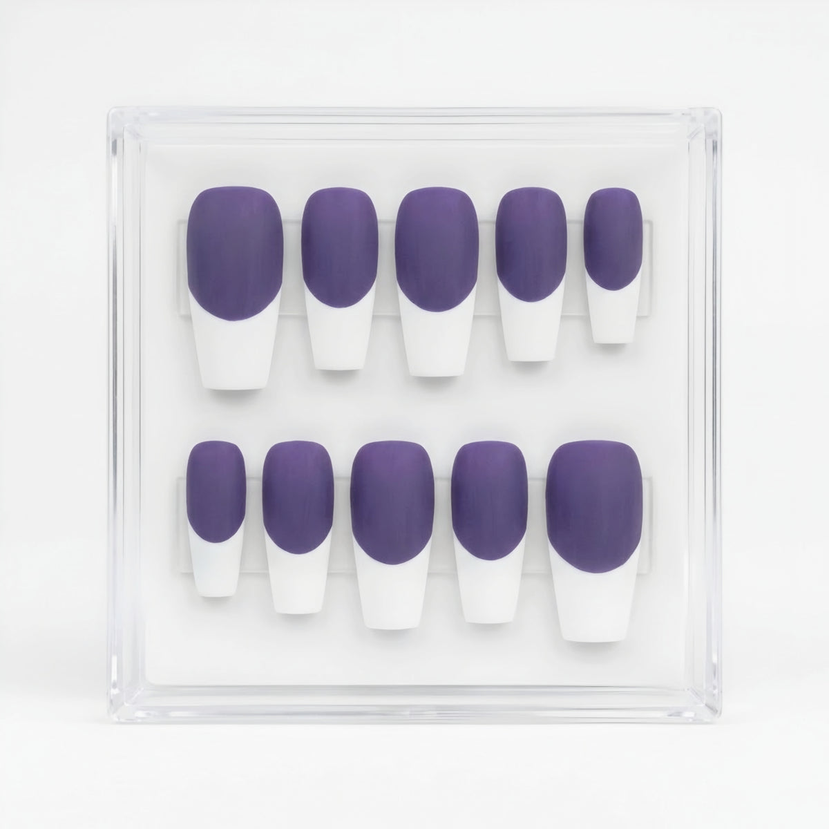 A set of 10 press-on nails with a purple and white French tip design, displayed inside a clear plastic case on a white background.
