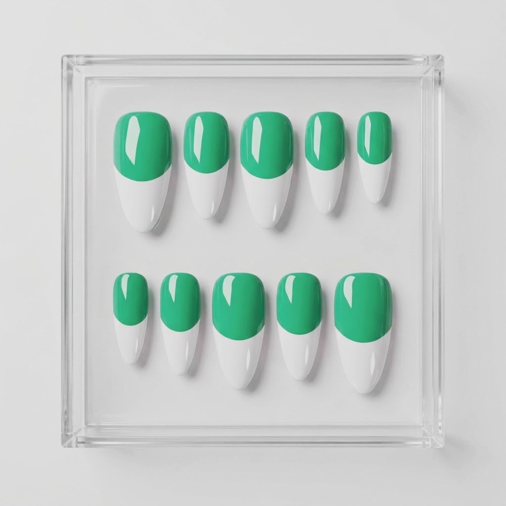 Ten false press-on nails arranged in two rows inside a clear square acrylic tray, featuring a green base and white french tip design on a light gray background.