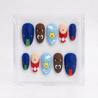 A set of 10 matte press-on nails displayed inside a clear acrylic case, featuring Mario-inspired designs including blue, brown, red, light blue, and yellow colors.