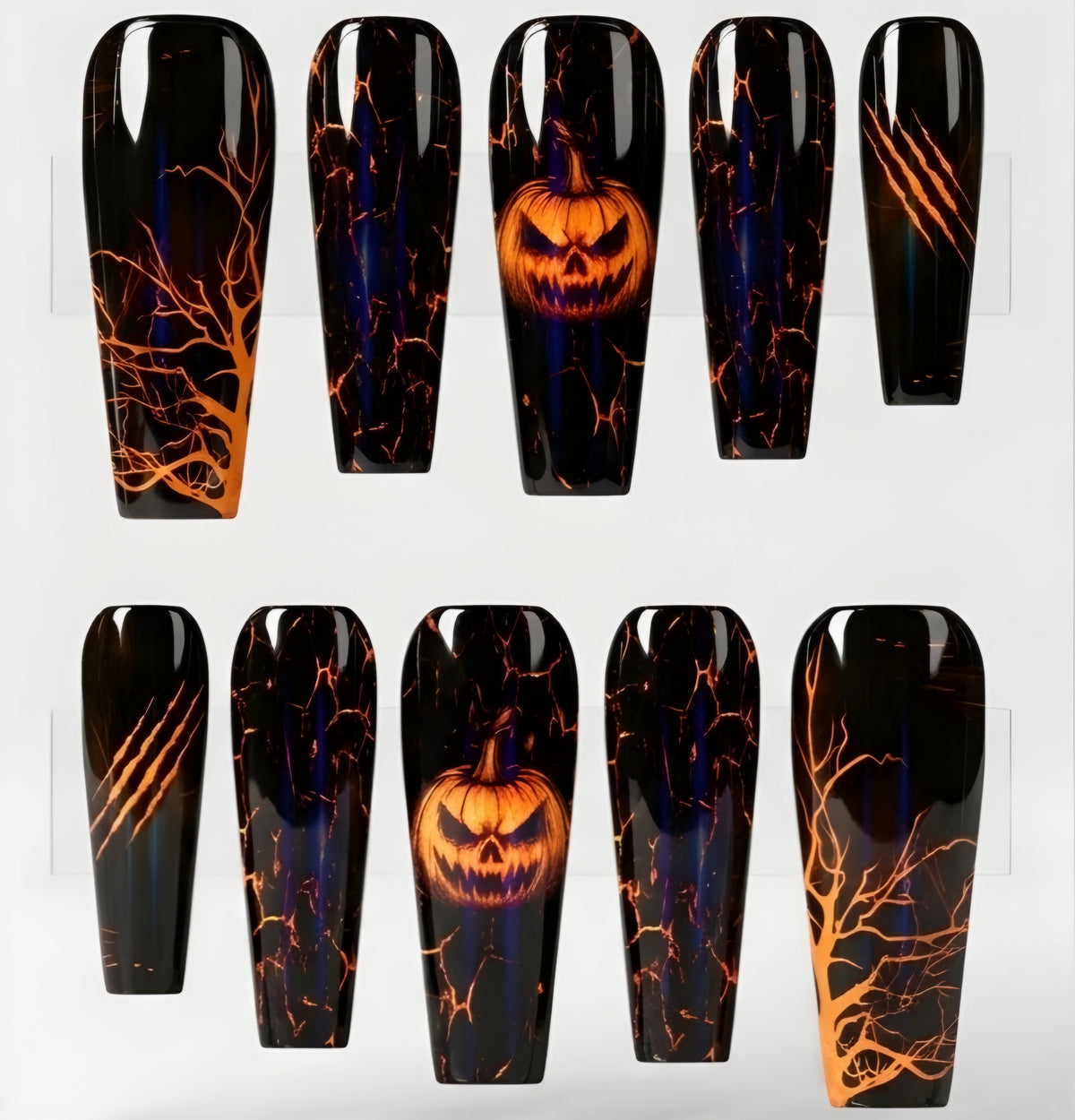 A set of coffin-shaped press-on nails displayed on a white background, featuring a Halloween theme with black glossy bases, orange glowing jack-o'-lantern faces, and orange crackle tree branch patterns.