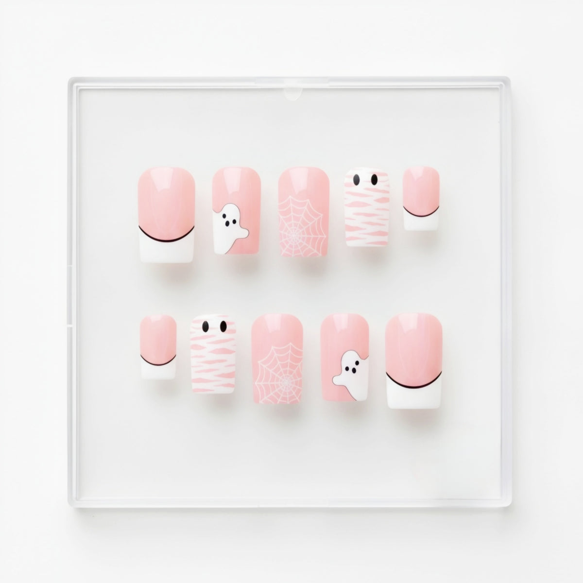 A set of 10 Halloween-themed glossy press-on nails displayed in a clear plastic case on a white background. The nails feature pastel pink and white designs with cute spooky illustrations including ghosts, spiderwebs, bandages, and a crescent moon.