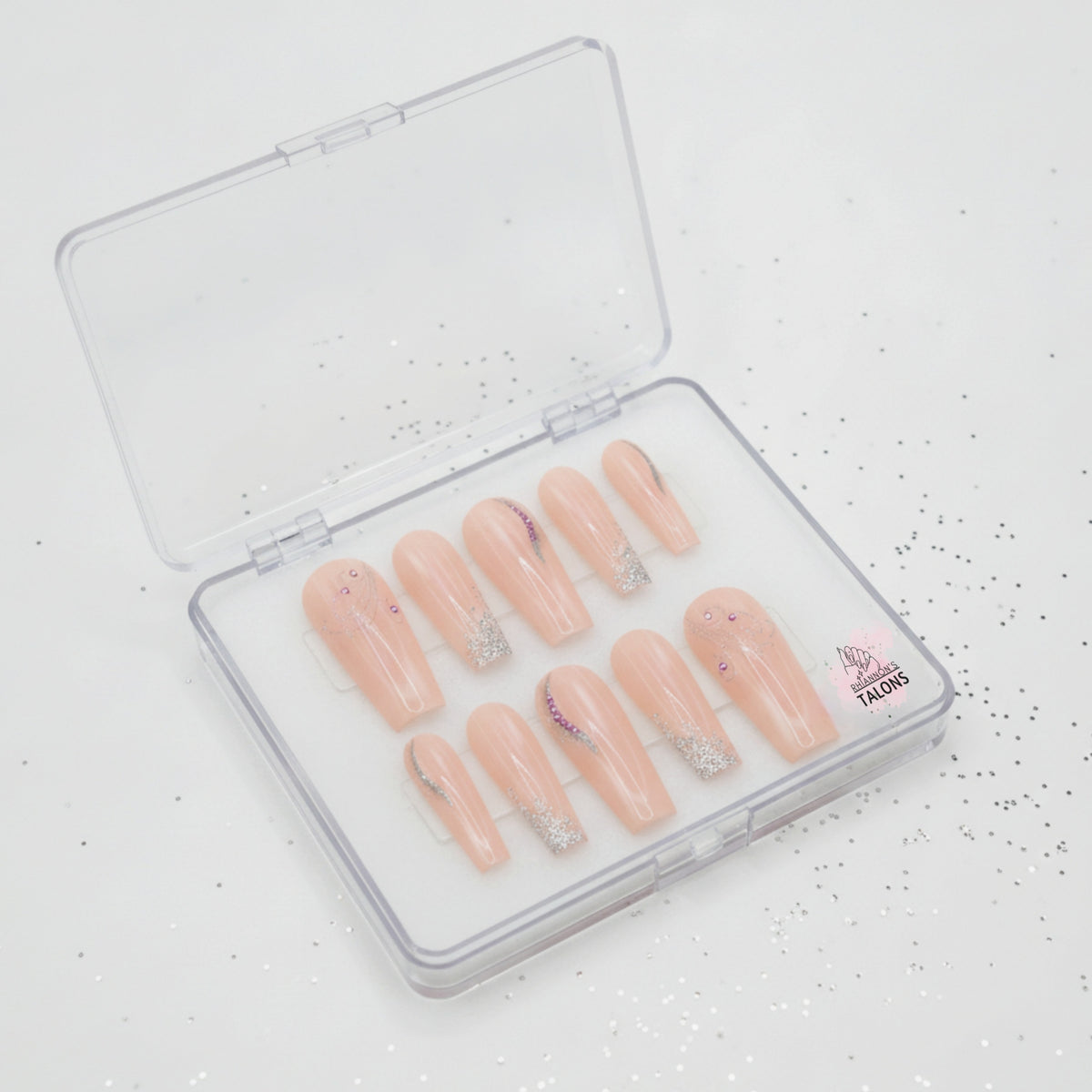 Peach Stardust peach press-on nails with silver glitter and crystal nail art