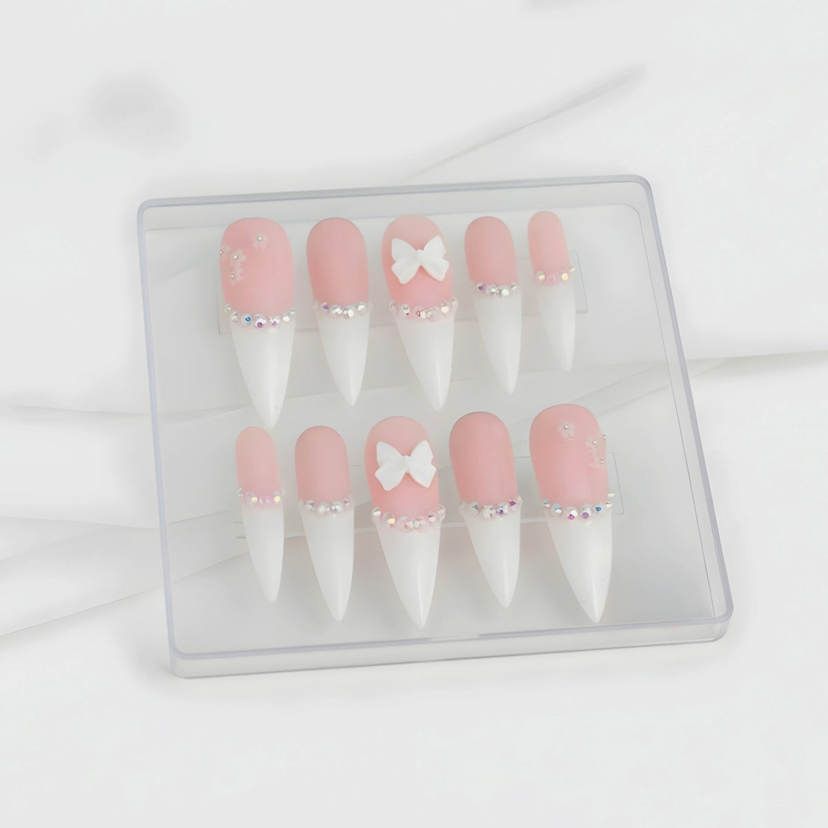 Pink Princess pink press-on nails with crystals, flowers and 3D white bows