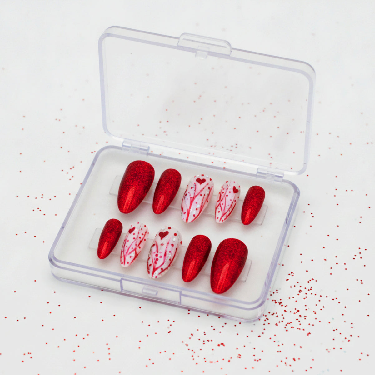 True Romance red glitter press-on nails with heart and silver nail art