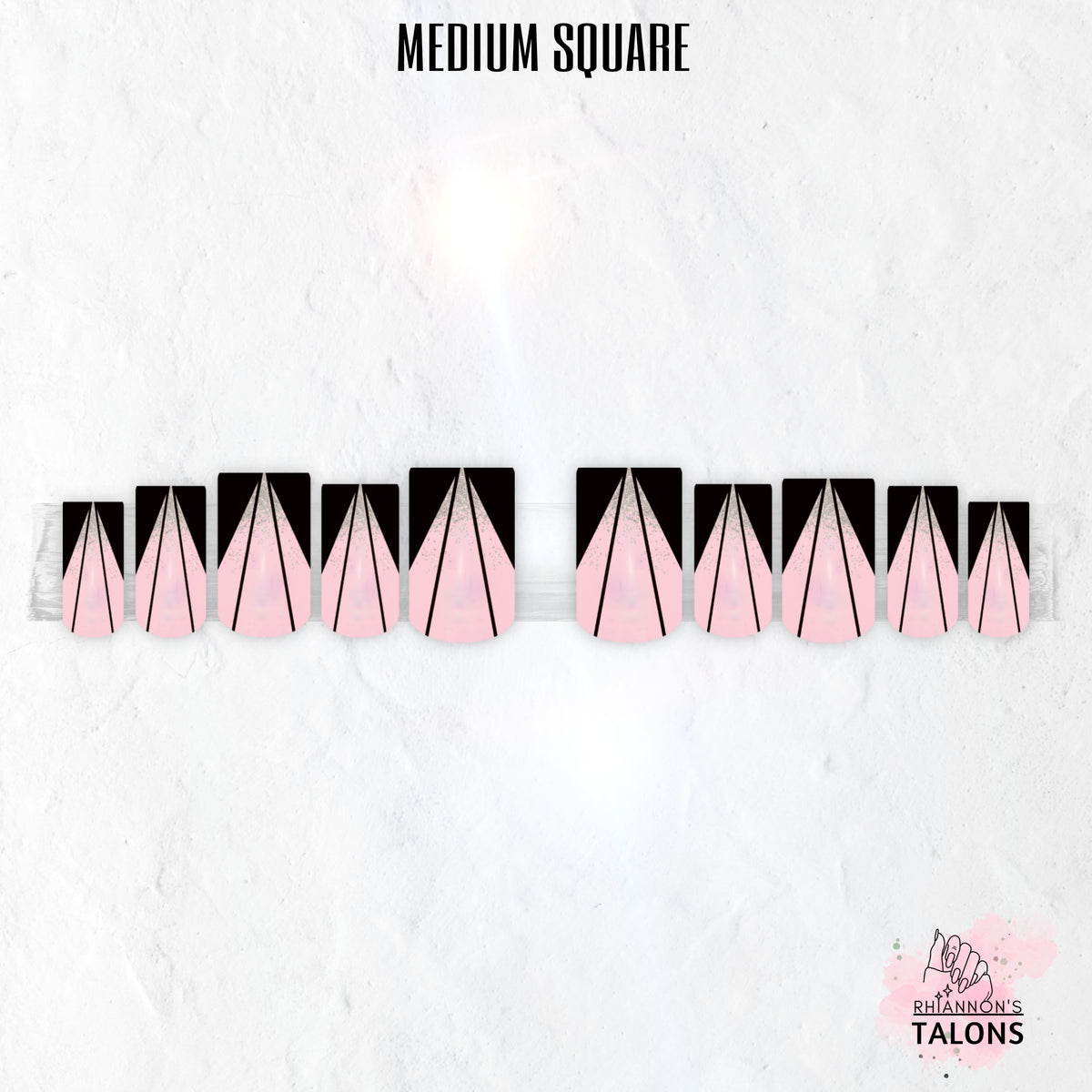 Pink Cut pink and black press-on nails with sharp V-cut line nail art, glitter accents and glossy medium square false nails.