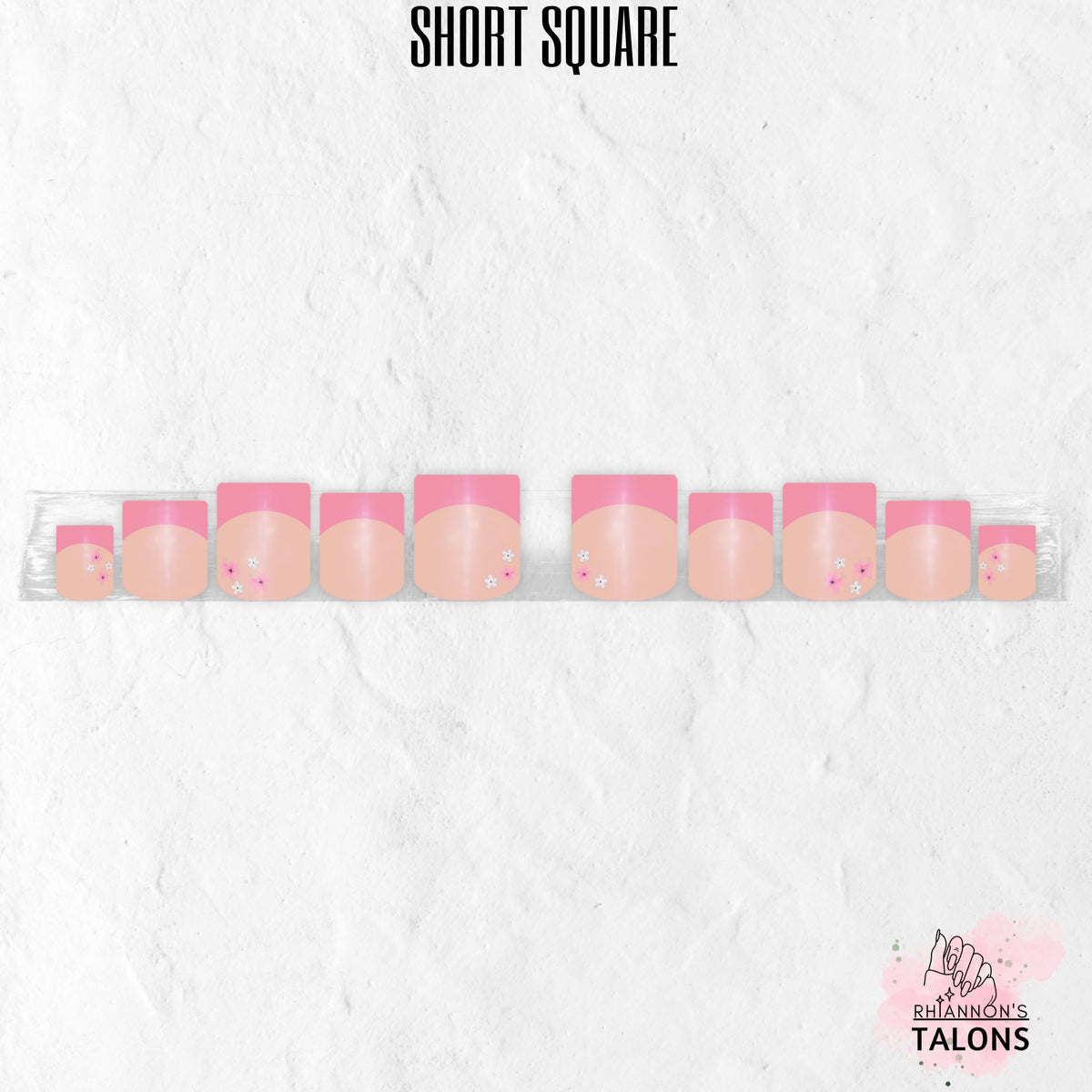 Pink Petal French pink French tip press-on nails with delicate floral accents in short square shape