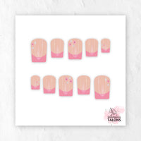 Pink Petal French pink French tip press-on nails with delicate floral accents in short square shape