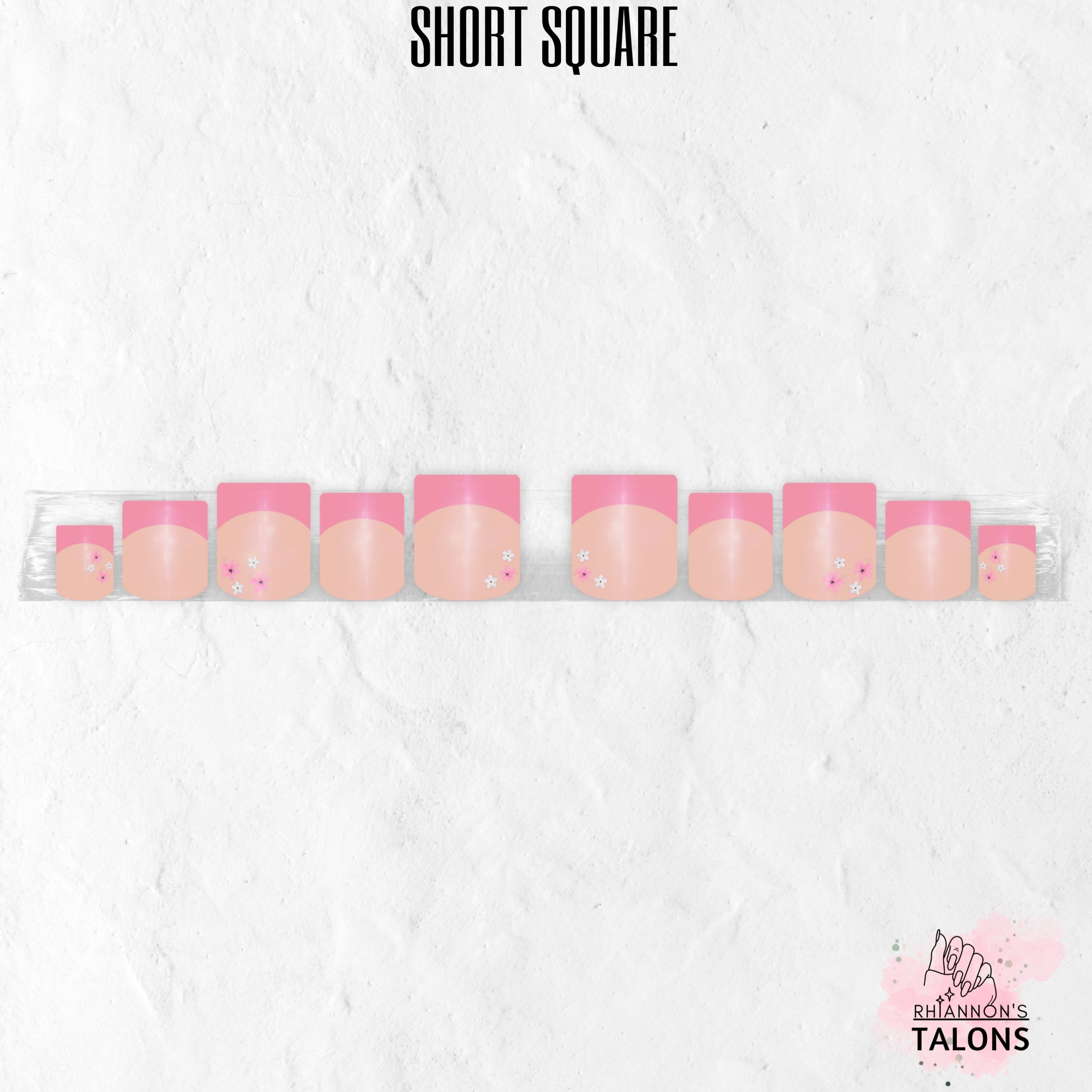 Pink Petal French pink French tip press-on nails with delicate floral accents in short square shape