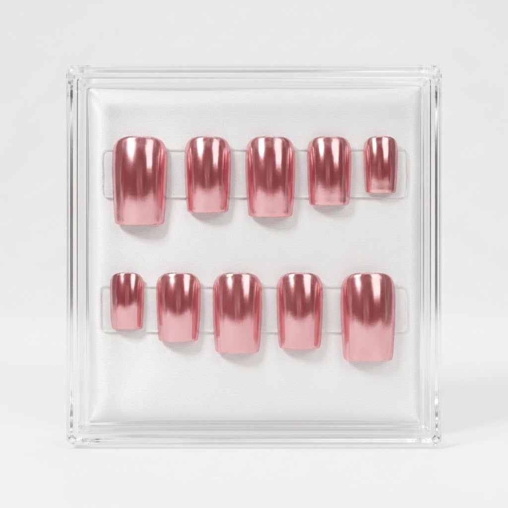 A set of 10 press-on nails light pink metallic chrome colour, displayed in a clear acrylic case against a light gray background.