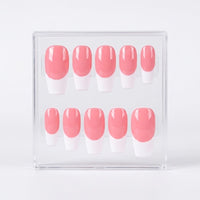 A set of 10 press-on nails with a pink and white French tip design, displayed inside a clear plastic case on a light gray background.