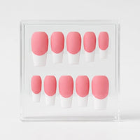 A set of 10 press-on nails with a pink and white French tip design, displayed inside a clear acrylic case on a light gray background.