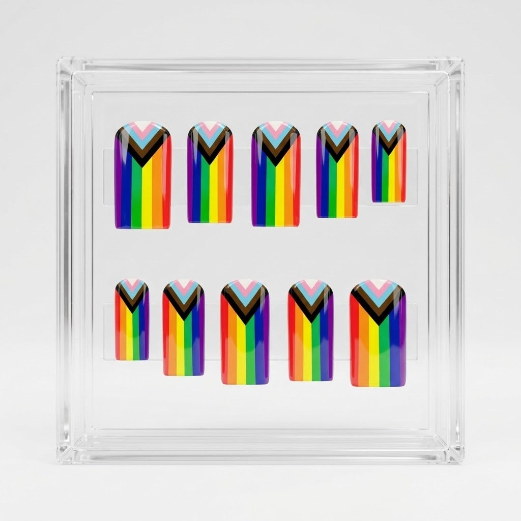 A set of 10 square glossy press on nails featuring a rainbow pride flag. Displayed on a clear display case on a white background.